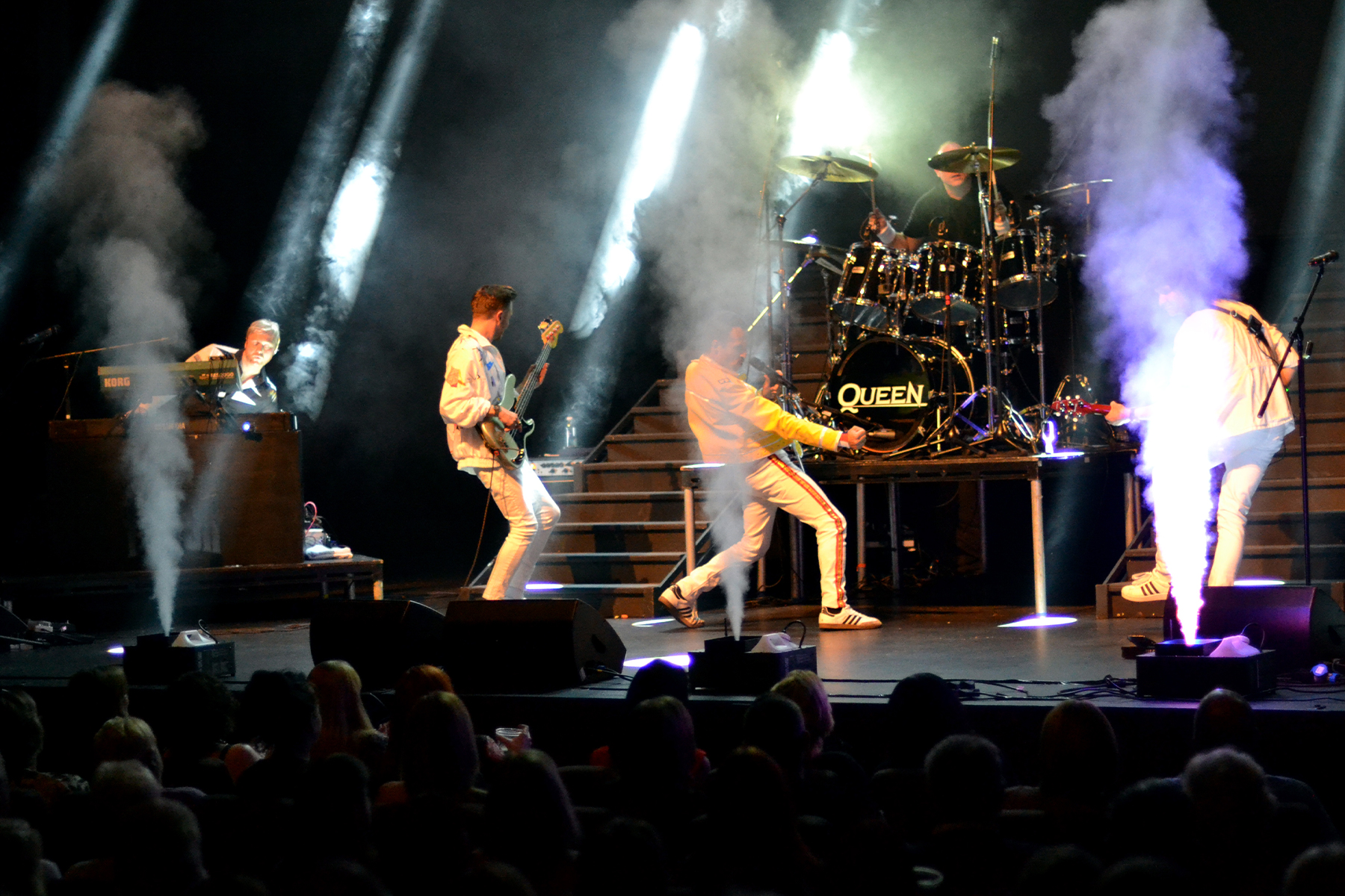 Full band powering through a number with CO2 jets erupting across the stage