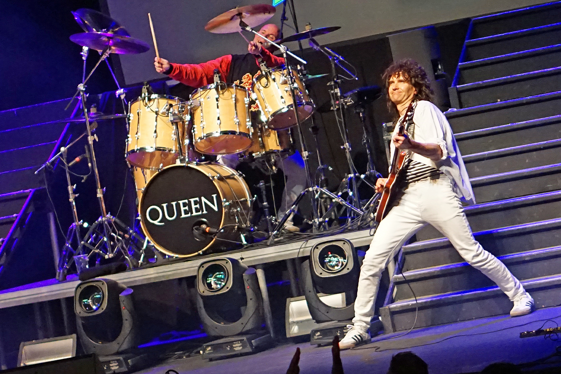 Brian on the upper riser beside the drummer behind the Queen kit